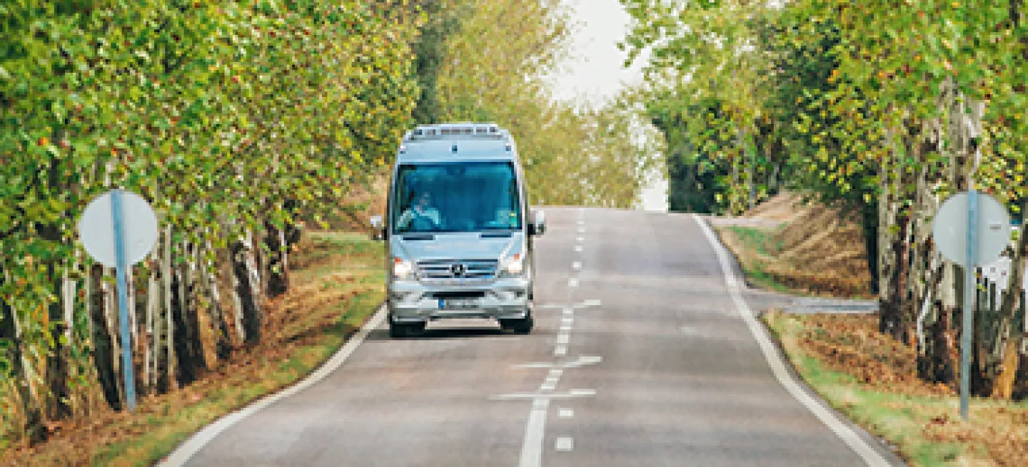 Back-Roads mini-coach driving along a road.