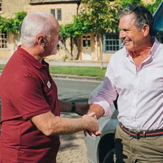 Guest being greeted by a Tour Leader. 