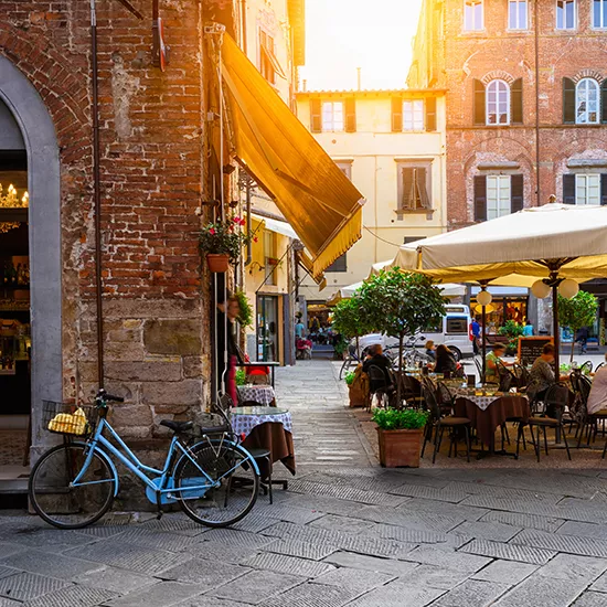 A view of a town square in Lucca, during a quiet and cozy sunset.